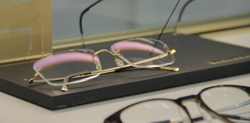 A close-up of a pair of rimless LINDBERG glasses at Optix
