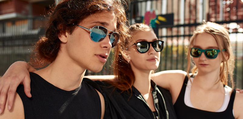 A group of friends outside, wearing sunglasses